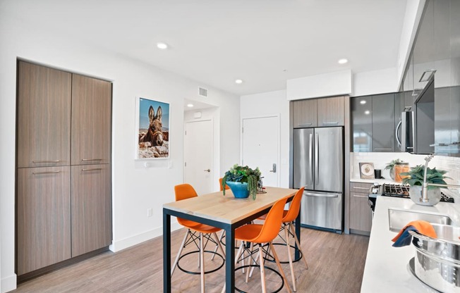 a kitchen and dining room with a table and chairs