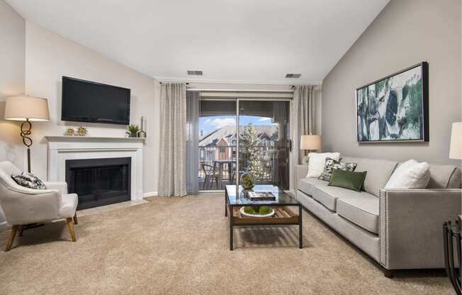 a living room with a couch and a chair and a fireplace
