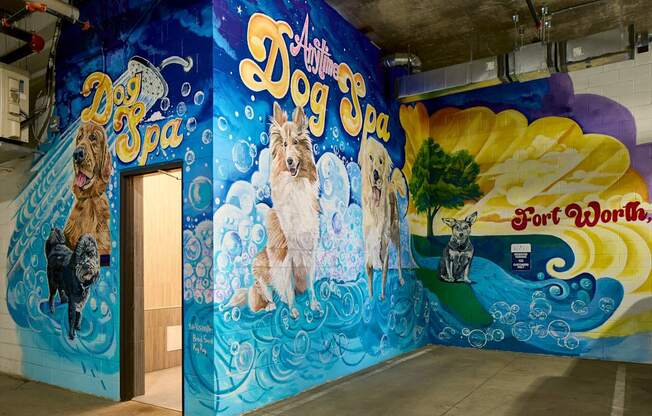 A mural of dogs painted on a wall in a room.