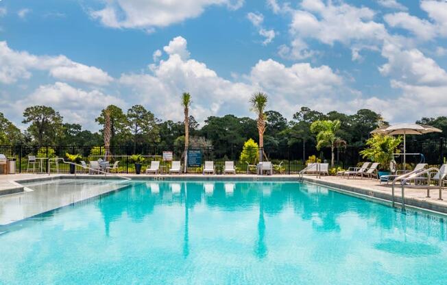 The pool with palm trees at the Flats at Sundown in North Port, Florida