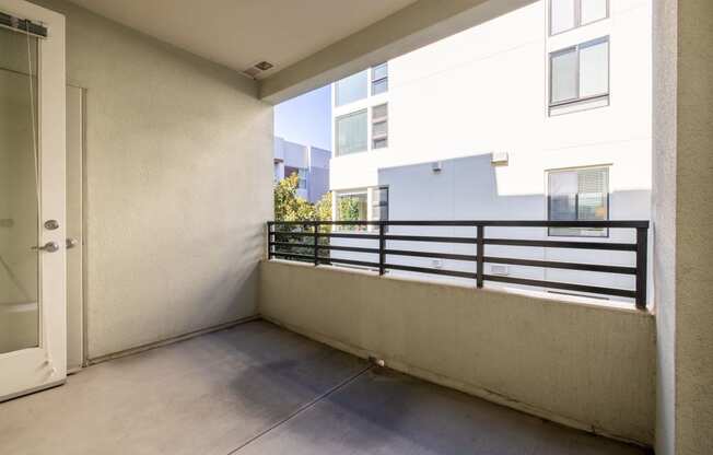 a balcony with a door and a railing