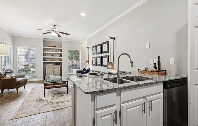 A kitchen with a marble countertop and a ceiling fan.