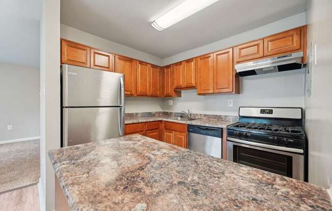 an updated kitchen with granite counter tops and stainless steel appliances at ReNew Odenton