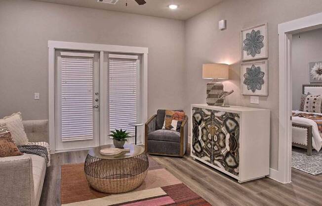 a living room with a couch and a chair at Hunters Creek Apartments, Texas, 76210