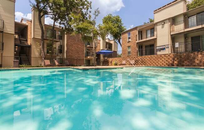 This is a photo of the pool area at Canyon Creek Apartments in Dallas, TX.
