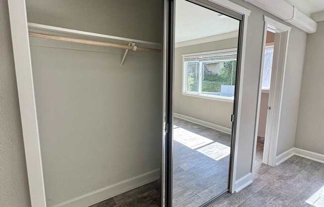 A room with a sliding glass door and a grey carpet.