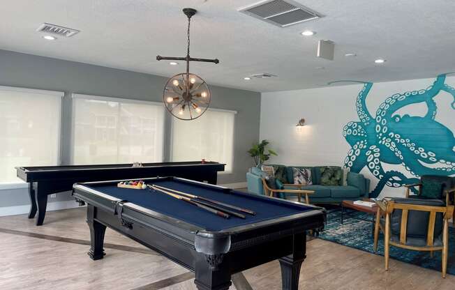 a games room with a pool table and a snooker table