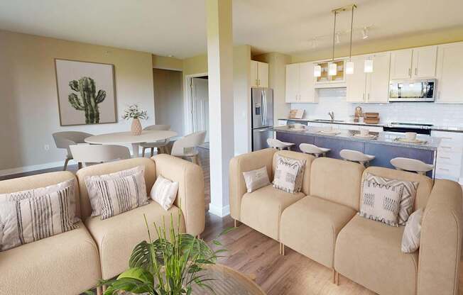 A living room with a couch and a dining area in the background.