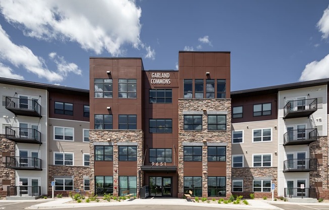 an exterior view of an apartment building with stone and brown exterior walls