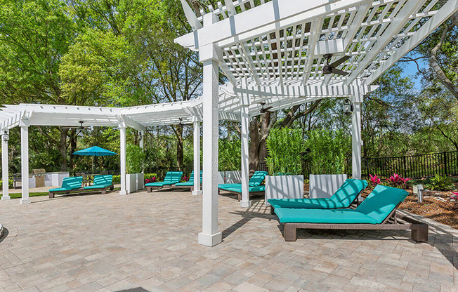 Community Patio with Pool Furniture at Grand Pavilion Apartments in Tampa, FL.