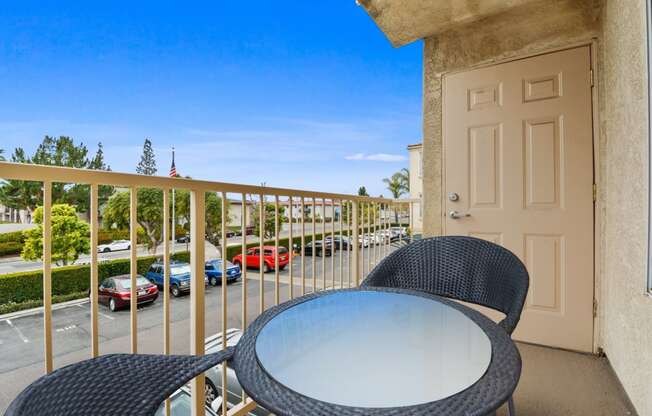 a balcony with a table and chairs and a door