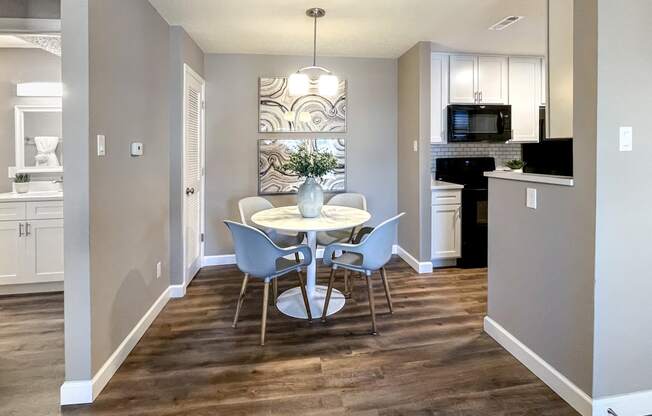 a kitchen and dining room with a table and chairs