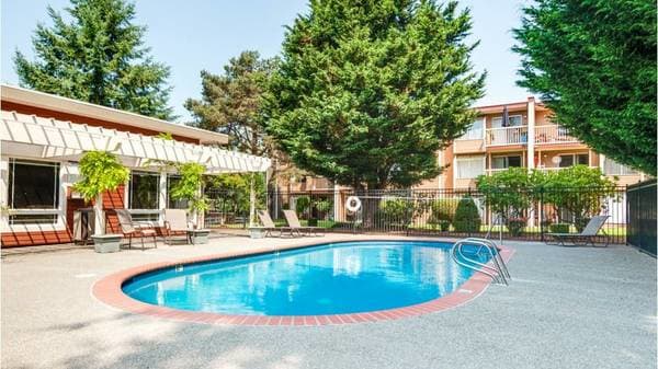 a large swimming pool in front of a building