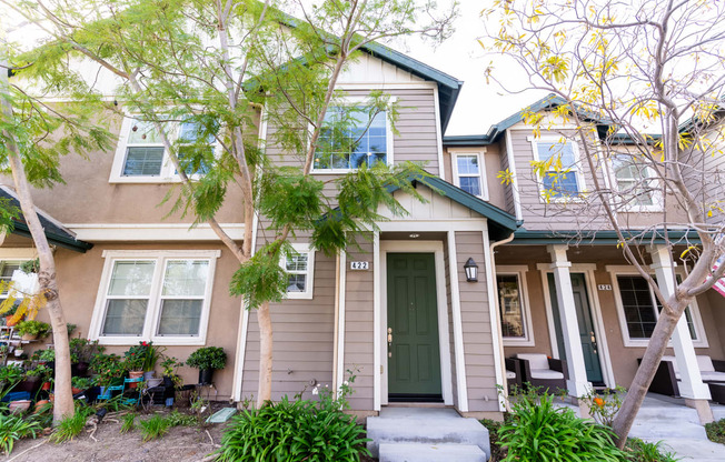 the front of a 2 story with a green door at The Vines at Riverpark, LLC, California, 93036