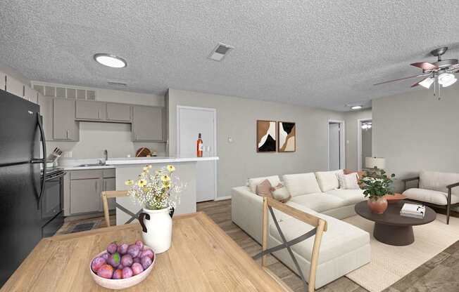 A modern kitchen with a black refrigerator and a dining table with a bowl of fruit on it.