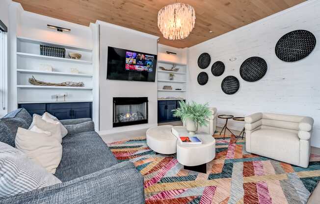 a living room with a fireplace and a tv on the wall