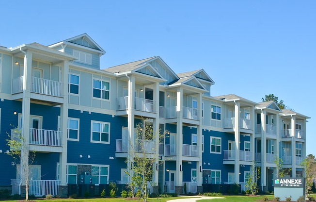 Apartment complex with blue and white buildings and a sign that says "ANNEXE".