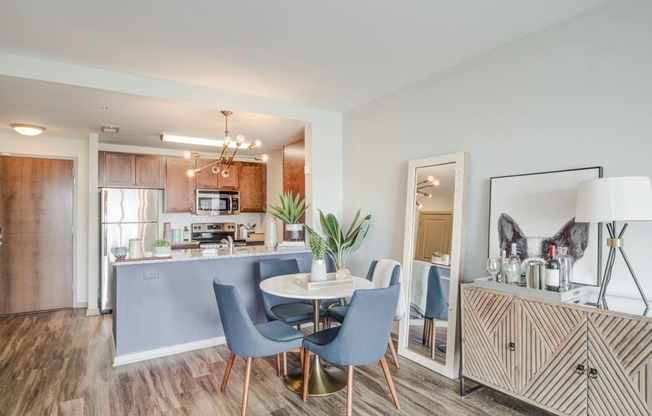 a dining room and kitchen with a table and chairs