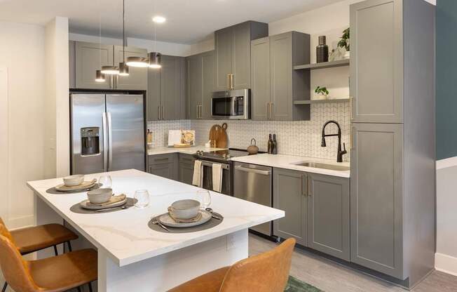 a kitchen with stainless steel appliances and a white table