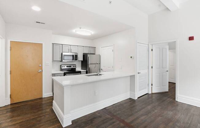A kitchen area with a microwave, oven, and refrigerator.