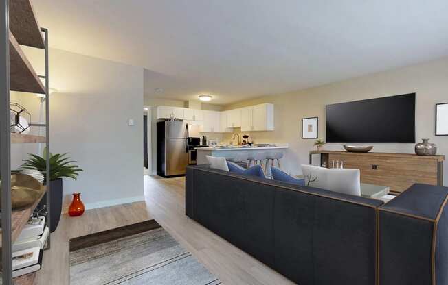 Staged, open layout living space that flows into an L-shaped Kitchen. Living room contains large sofa sectional. at 3030 Lake City, Seattle, 98125