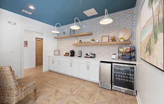 A clubhouse kitchen with a white fridge and a white wall at The Palms at Chatham apartments in Savannah GA.
