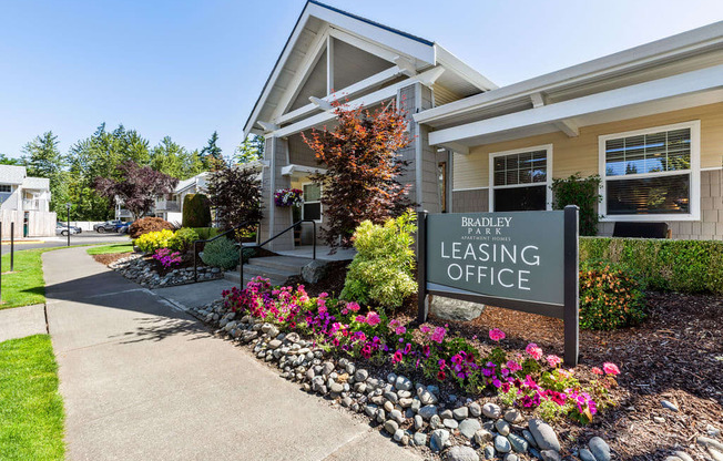 A Bradley Leasing Office is surrounded by flowers and greenery.