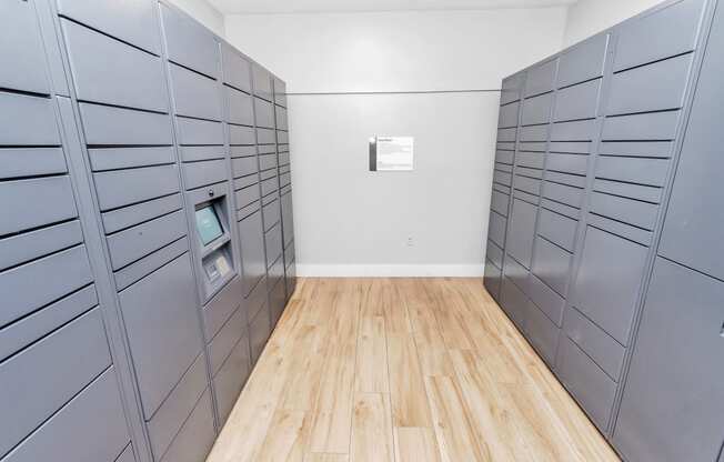 a room with gray lockers and a hardwood floor