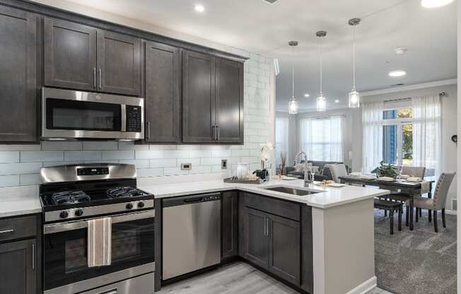 a kitchen with stainless steel appliances and a large island with a sink