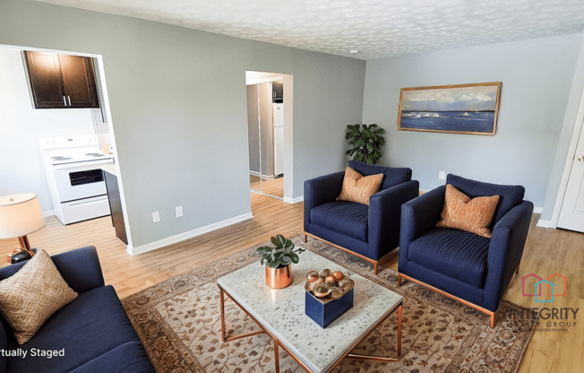 A living room with a blue couch and a coffee table.