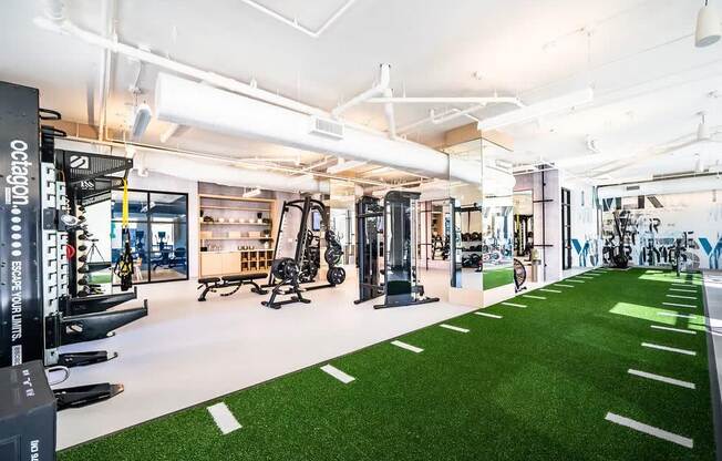 a gym with artificial turf and equipment on the floor