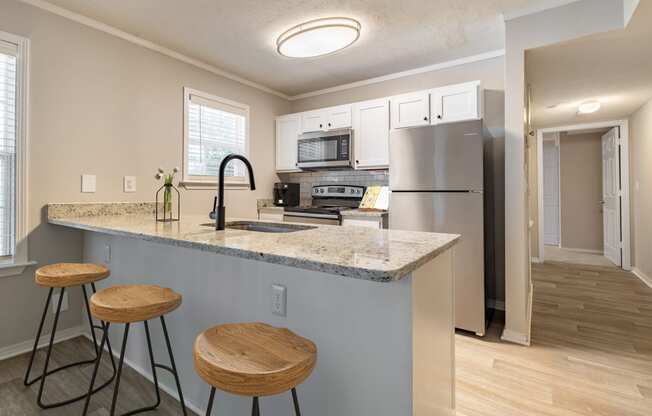 a kitchen with a breakfast bar and stools