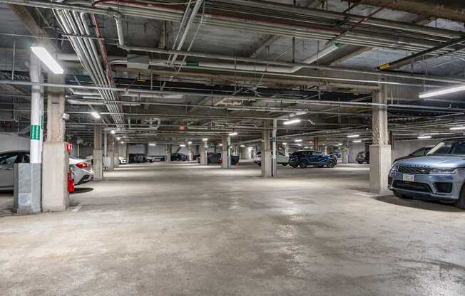 A spacious parking garage with multiple cars parked.