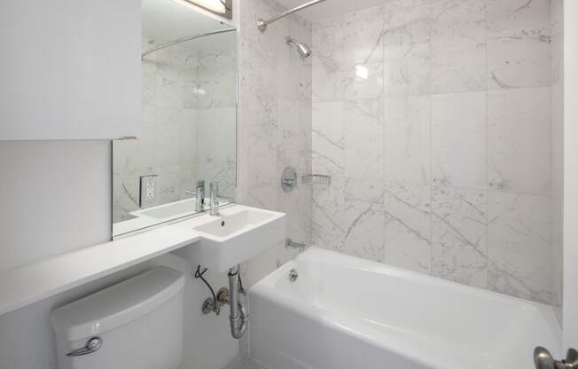 a bathroom with a toilet sink and bathtub