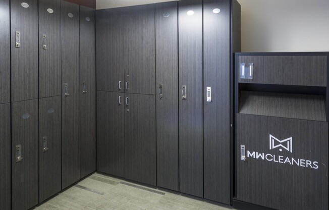 Full-length and half-length lockers with a dark wood-style finish and a logo reading "MW Cleaners."