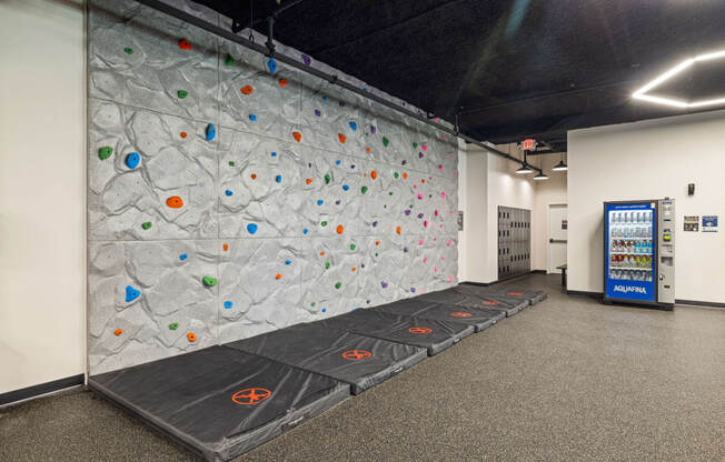 a climbing wall in a room with a vending machine at EagleRidge Plaza Residences, North Dakota