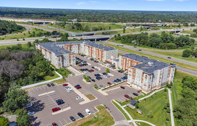 an aerial view of an apartment complex and parking lot