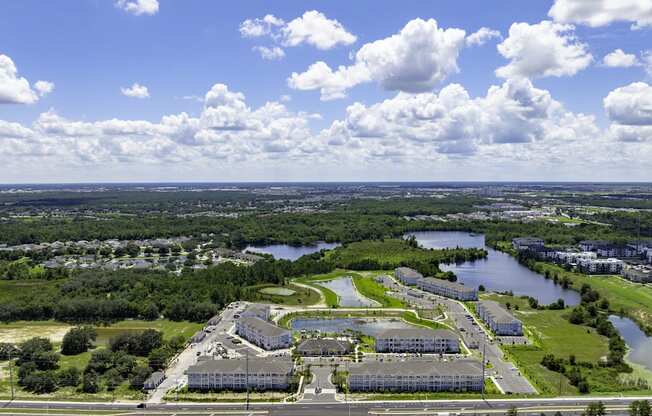 an aerial view of a campus with a body of water