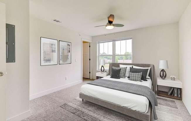 A bedroom with a large bed, a walk-in closet and a ceiling fan at Stoney Pointe Apartment Homes, Wichita, KS