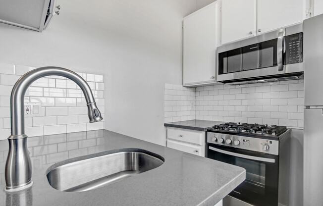 a kitchen with a sink and a microwave