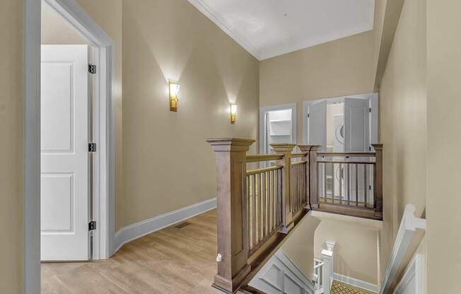 the landing of a staircase in a home with a door to a hallway at The Knights @ 506 Delaware Apartments, Buffalo, NY