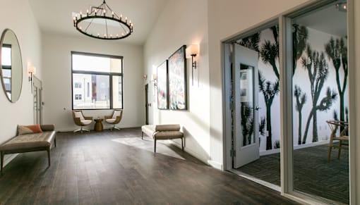 A room with a large window and a view of trees outside.