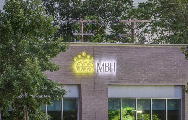 a building with the mbh logo on the front of it