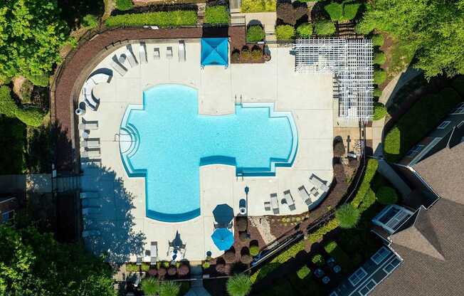 An aerial view of a pool with a blue water slide.