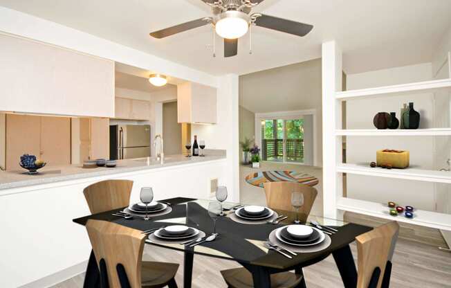 a dining room with a table and a ceiling fan