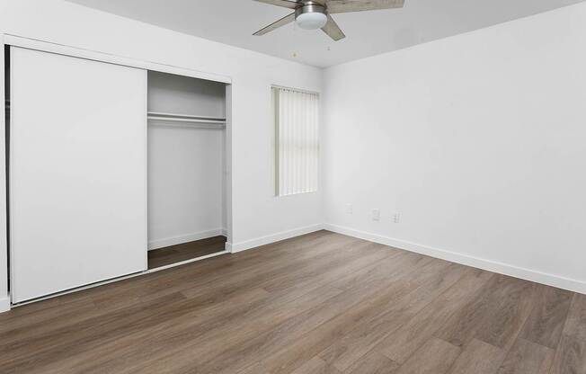 A room with a sliding door and a ceiling fan.