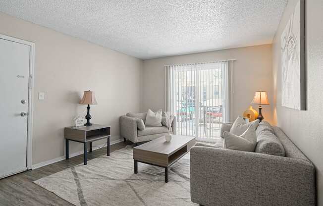 a living room with a couch and a table and a sliding glass door