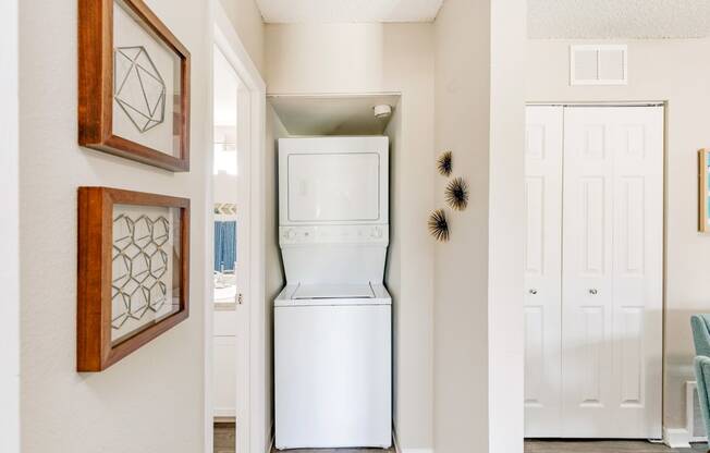Stacked washer and dryer next to the bathroom