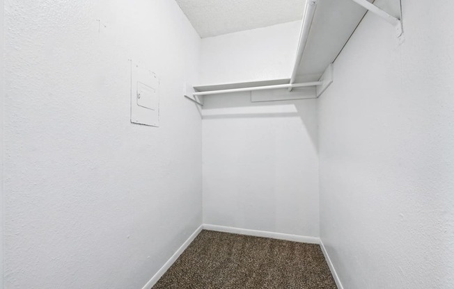 A white wall with a small white square object on it.