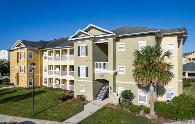 A building with a palm tree in front of it.